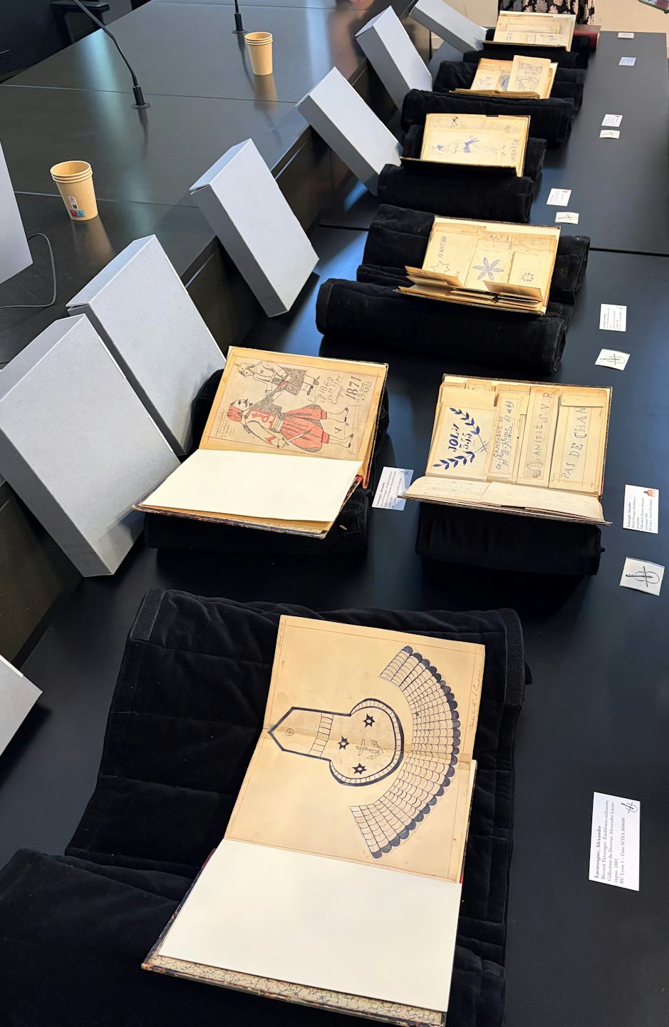 Historical manuscripts and documents displayed on a long table.